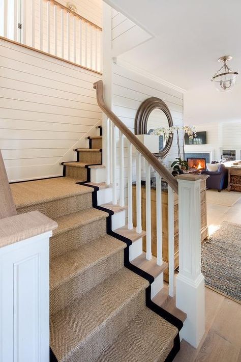 Cottage home with a white wood spindle staircase features a black bound sisal runner on gray wash wood stairs. Cottage Staircase, Cottage Stairs, Carpet Staircase, Staircase Runner, Staircase Makeover, Hallway Designs, Entrance Foyer, Foyer Design, Wood Stairs