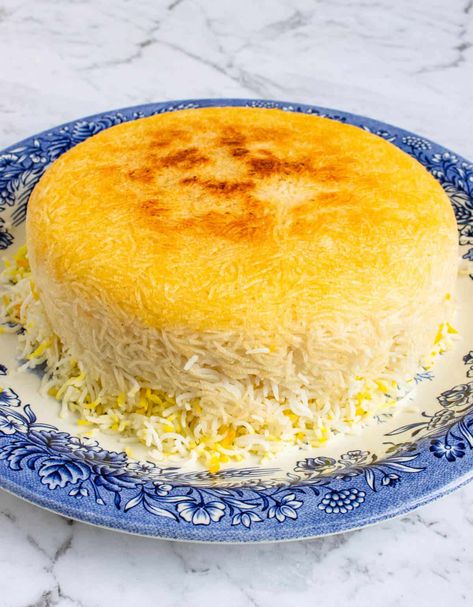 Persian Rice with Tahdig is a popular staple in Persian cuisine using basmati rice and saffron to create a golden crispy rice bottom. #tahdig #persian #persianfood #saffron #sidedish #rice Parmesan Crusted Potatoes, Persian Rice, Iranian Recipes, Parboiled Rice, Perfect Rice, Persian Cuisine, Crispy Rice, Parmesan Crusted, Persian Food