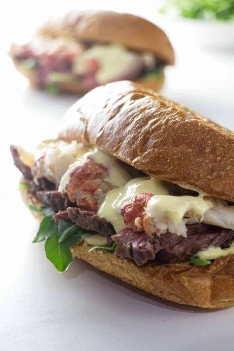 Steak and lobster sandwich on a garlic bread roll and topped with a blender hollandaise sauce. #steakandlobster #surfandturf #steakandlobstertail #steaksandwich #lobstertail #sandwich #surfandturfrecipes #surfandturfideas #savorthebest Garlic Bread Steak Sandwich, Lobster Roll Sandwich Recipe, Steak Sandwich With Garlic Aioli, Sauteed Lobster Meat, Lobster Grilled Cheese Sandwich, Surf N Turf Recipes, Steak And Lobster Dinner, Lobster Sandwich, Lunch Dishes