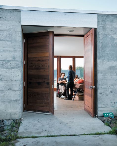 Concrete and glass farmhouse nestled in an orchard Concrete Farmhouse, Wide Front Doors, Orchard House, Rocky Mountain Hardware, Dwell Magazine, Slab Table, Modern Door, Types Of Doors, Dream Design