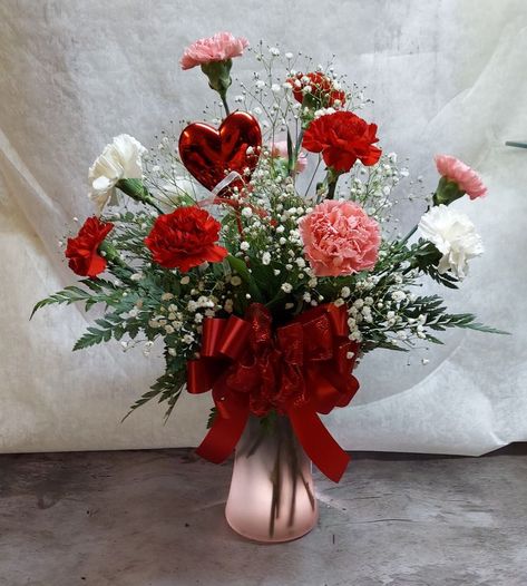 Send your Valentine a very special mix of red, white , and pink carnations with baby's breath and greenery. Designed in a pink vase with a with a heart pick. Valentine's 💘 Day is Monday, Feb. 14th. Order now for best selection! #jensensflowersandgifts #shoplocal #roses #TellYourLoveStorywithFlowers #flowers #handcrafted #bouquet #flowerlove #iloveyou #sweetie #sweetheart #valentines #valentinesday #feb14th #love #heart A With A Heart, Valentines Floral Arrangements, Sweetheart Valentines, Flower Shop Display, Valentine Flower Arrangements, Floral Arrangement Ideas, Valentine Centerpieces, Diy Floral Decor, Creative Flower Arrangements