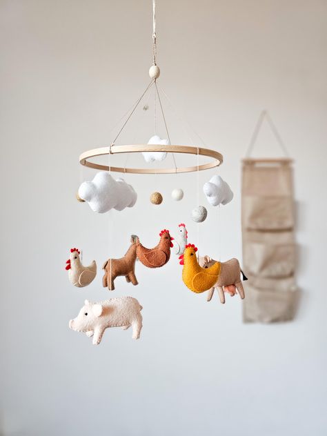 The farm baby mobile brings a charming country farmhouse feel to your little one's nursery. Featuring adorable animals like a cow, goat, chicken, and pig, this delightful mobile is perfect for adding a touch of animal nursery decor to create a cozy and playful environment for your baby. ☑️ BABY MOBILE INCLUDES: - 1 pig - 1 cow - 1 goat - 4 small chickens  - 4 clouds - 3 felt balls ☑️ You can also buy music box ➡️ www.etsy.com/listing/1162035340 💛 If you have any questions about the product, fee Pig Themed Nursery, Chicken Nursery Theme, Chicken Themed Baby Shower Ideas, Farm Nursery Ideas, Farmhouse Baby Nursery, Farm Nursery Boy, Farm Animals Nursery Theme, Farm Theme Nursery, Farm Animals Nursery