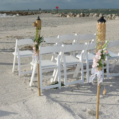 Tiki torches with flowers and fabric are always a creative touch! Tiki Torch Wedding Aisle, Tiki Torches Wedding, Dock Wedding, Cruise Ship Wedding, Beach Wedding Aisles, Sunset Beach Weddings, Berry Wedding, Wedding Alters, Purple Sunset