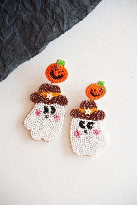 Saddle up for Halloween with our Cowboy Ghost Dangle Earrings, where whimsy meets the Wild West. Each earring features a playful combination of a beaded ghost and pumpkin, capturing the spirit of the season with a touch of cowboy charm. Perfect for adding a unique twist to your Halloween attire, whether you're wrangling candy or two-stepping at a spooky soirée. Embrace the frontier of festive fun with these earrings that blend playful design with a hint of Halloween mystery. Beaded Ghost, Halloween Beading, Beaded Halloween, Cowboy Ghost, Halloween Mystery, Seed Bead Crafts, Pumpkin Bead, Halloween Beads, Ghost Earrings