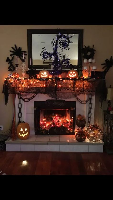 50+ Haunting Halloween Mantle Decor Ideas for a Spooky Yet Fun Vibe Spooky Fireplace Mantle, Halloween Decorated Fireplace, Halloween Mantle Ideas Fireplaces, Halloween Chimney Decor, Halloween Fireplace Decor Mantles, Mantle Halloween Decor, Halloween Decorations Fireplace, Tv Halloween Decor, Fireplace Halloween Decor