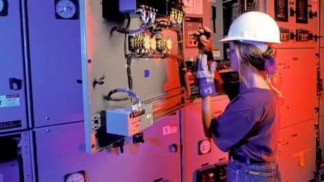 A female electrician works on electrical mains with a screwdriver Female Electrician Aesthetic, Woman Electrician, Electrician Aesthetic, Women Electrician, Female Electrician, Electricity Art, Electrician Work, Trade School, Art Concepts