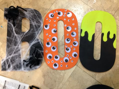 Diy fun boo letters.  Black acrylic paint Pumpkin acrylic paint Wasabi acrylic paint Googly eyes Pipe cleaners (black)  Pom poms (black)  Spider web  Glue gun  Paint brush  Enjoy!!  Happy Halloween. I got the letters, pipe cleaners, paint, Pom poms, and glue gun from hobby lobby. And the spider web from dollar tree. Letter E Halloween Crafts, Happy Halloween Signs Diy, Boo Letters Halloween, Paint Pumpkin, Halloween Signs Diy, Halloween Arts, Painting Wooden Letters, Halloween Wood Signs, Happy Halloween Signs