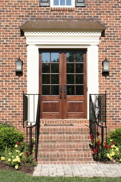 Double wood front doors on brick. Wood Front Door Brick House, Red Brick House Double Front Door, Double Front Door With Transom Above, Colonial Double Door, Mahogany Double Doors Front Entry, Double Wood Front Doors, Double Door Entryway Exterior Us Door & More Inc, Brick Colonial House, Double Doors Exterior