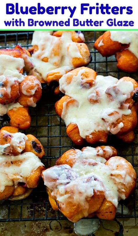 Blueberry Fritters with Browned Butter Glaze. #breakfast Blueberry Fritter Bread, Air Fryer Blueberry Fritters, Baked Blueberry Greek Yogurt Fritters, Blueberry Fritters Recipe, Blueberry Greek Yogurt Fritters, Blueberry Fritters, Blueberry Glazed Doughnut, Blueberry Glaze, Spicy Southern Kitchen