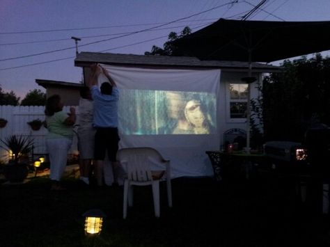 Family time. Put white sheet on wall and display movie from projector. Projector On Wall, Projector Outside, Backyard Projector Screen, Outdoor Movie Projector Screen, Diy Projector Screen, Backyard Movie Screen, Summerween Party, Projector Screen Diy, Movie Projector Screen