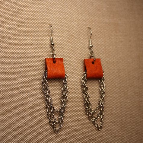 Orange leather loop and silver tone chain loop hook earrings On silver tone earring hooks Approximate length: 3 inches Approximate width: 3/4 (0.75) inches Quality leather remnants were used to create these earrings in an effort to reduce the amount of wasted leather from other shops  *The earrings pictured are the exact pair that you will receive if you purchase this listing* Leather Earrings Ideas, Feather Earrings Diy, Leather Jewelry Making, Diy Leather Earrings, Leather Accessories Handmade, Winchester Va, Cord Jewelry, Chain Loop, Boho Leather