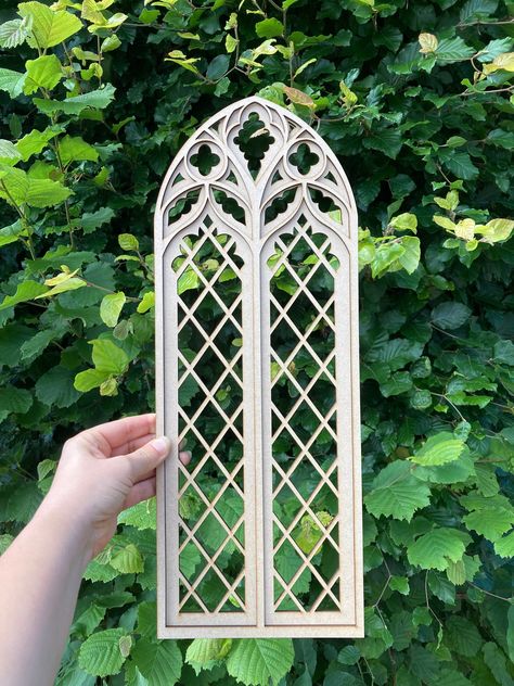 Transform your home with our exquisite Cathedral Gothic Tracery Window Wall Decor, meticulously crafted from high-quality MDF. This stunning piece features a two-layer design that adds depth and dimension, bringing a touch of architectural elegance and timeless charm to any space. Size- 13" x 4,9"   Key Features: Material: Made from premium MDF, ensuring durability and a smooth finish. Design: Inspired by the intricate tracery of Gothic cathedrals, this decor piece captures the beauty of historic craftsmanship with its ornate patterns and graceful arches. Two-Layer Construction: The dual-layer design enhances the visual depth, creating a captivating shadow effect that changes with the lighting in your room. Customizable Size: Available in various sizes to perfectly fit your space. Whether Gothic Cathedral Window, Gothic Revival Decor, Tracery Window, Altar Diy, Victorian Goth Decor, Cardboard Decorations, Gothic Tracery, Gothic Frame, Gothic Arches