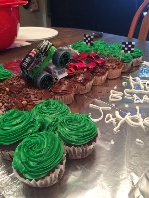 1st birthday monster truck cupcakes. Vanilla and chocolate cupcakes in shape of 1 Monster Truck Birthday Cake Cupcakes, Diy Monster Jam Cake, Monster Jam Cupcake Cake, Cupcake Monster Truck, Monster Jam Cupcakes Ideas, Monster Jam Birthday Cupcakes, Monster Truck Pull Apart Cupcakes, Girls Monster Truck Birthday Party, Monster Truck Birthday Cupcakes