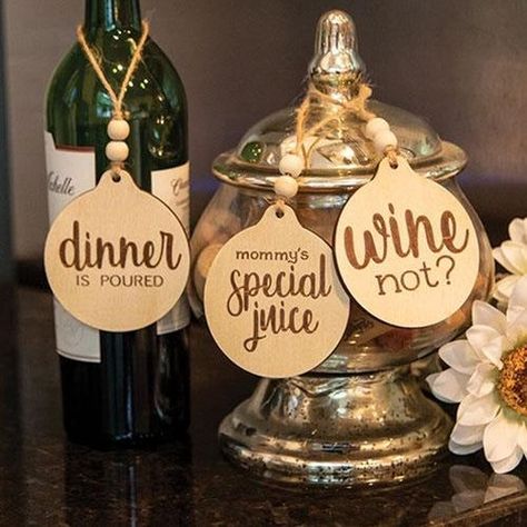 The Dinner Is Poured Wine Tag is an assortment of three wooden tag ornaments featuring etched scripted lettering and a wine theme. One tag reads “wine not?”, the second tag reads “mommy’s special juice”, and the third tag reads “dinner is poured”. Each tag includes a jute rope loop, strung with two wooden beads, attached to the top for a hanging display. Each tag measures 3.5” high by 3” long. Please note: This item features a variety of designs which are each sold individually (not as a set). Tag Ornaments, Wine Bottle Gift Tags, Bottle Gift Tags, Wine Bottle Charms, Wine Bottle Tags, Wine Craft, Bottle Tags, Wine Tags, Wooden Tags