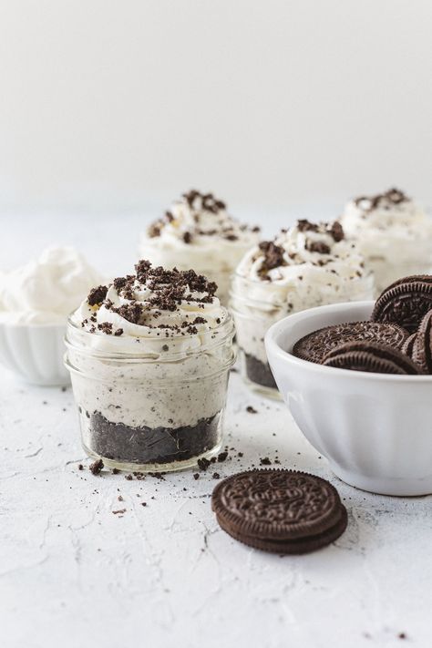 No Bake Oreo Cheesecake Jars are full of cookies-and-cream flavor! An easy, no bake, make ahead, and indulgent mason jar dessert. The jars are layered with a chocolate cookie crust, Oreo cheesecake filling, and homemade whipped cream. Top with cookie crumbles and the mini desserts are ready to eat! Mason Jar Cheesecake, Cheesecake Jars, Jar Desserts, Chocolate Cookie Crust, Raspberry Chocolate Chip, Pistachio Dessert, No Bake Oreo Cheesecake, Mason Jar Desserts, Cheesecake In A Jar