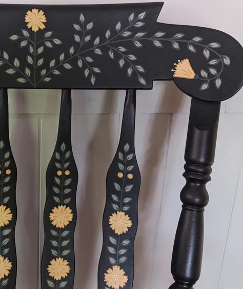 Large, solid wood, and super sturdy rocking chair. This is a repaint of my first rocking chair since I've decided to keep the last wooden one for now! The base color is a charcoal that appears more like dark blue in bright lighting. Lots of hand painted leaves, yellow flowers, and little gold details. 🌼 #handpaintedfurniture #handpaintedchair #handpaintedrockingchair #vintagerockingchair #rockingchair #accentchair #nurserydecor #nurserychair #fusionmineralpaint #colorfulhome #interiordesign ... Wooden Rocking Chair Makeover Ideas, Hand Painted Wooden Chairs, Painted Flower Furniture, Nordic Painted Furniture, Wooden Chair Painting Ideas, Cottagecore Painted Furniture, Folk Art Chair, Painted Wooden Stool, Hand Painted Bookshelf