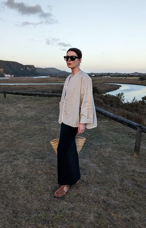 A woman stands on a hill in front of a river. She wears oversized sunglasses, a linen jacket, navy slip dress, basket bag and fisherman sandals. What To Wear In South Africa, South Africa Outfits, Activewear Inspiration, South Africa Fashion, November Outfits, Outfit Ideas For Summer, Loose Vest, Farm Clothes, Summer Vacation Outfits