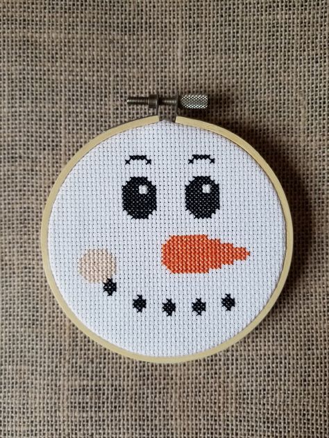 A snowman face counted cross stitch instant pdf download pattern. Design area measures 2.93" x 2.71" on 14 count aida.  Finished example piece pictured is in a 4" hoop. I'm happy to help so please feel free to contact me with any questions. Thank you! Snowman Cross Stitch Pattern Free, Easy Christmas Cross Stitch, Christmas Cross Stitch Patterns Free, Snowman Cross Stitch Pattern, Patterns Flowers, Tiny Cross Stitch, Face Pattern, Holiday Cross Stitch, Xmas Cross Stitch