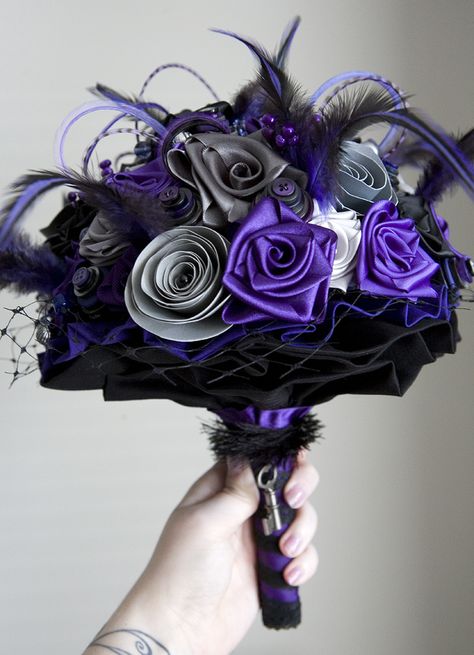 Wedding bouquet purple, black and grey. Ribbons and paper flowers, button stacks, feathers and beads. Wedding Dresses Black And Purple, Black And Purple Tuxedo Wedding, Purple Suit For Wedding, Lavender And Black Wedding Decorations, Blue Purple Black Wedding Theme, Purple Black And Silver Wedding, Black White And Purple Wedding, Purple And Black Wedding Dress, Purple And Black Wedding Theme