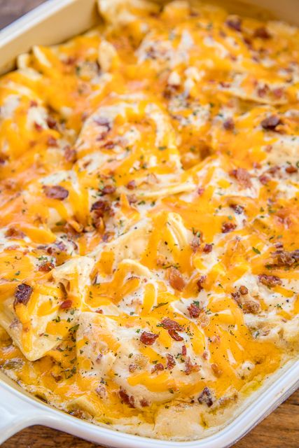 Crack Chicken Pierogi Casserole - CRAZY good!! Frozen pierogies tossed in alfredo sauce, ranch dressing mix, bacon, cheddar and chicken. Can make ahead and refrigerate or freeze for later. Everybody cleaned their plate and asked for seconds!! Weeknight dinner success!! #casserole #chicken #chickencasserole #bacon Chicken Pierogi Casserole, Pierogies Recipes, Precooked Bacon, Frozen Pierogies, Pierogi Casserole, Perogies Recipe, Baked Ranch Chicken, Pierogi Recipe, Casserole Chicken