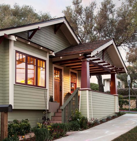 This home exudes a classic bungalow feel in Colonial Revival Green Stone SW 2826, with complementary trim in Navajo White SW 6126 and Rockwood Red SW 2802. With Sherwin-Williams, it's easy to find the best exterior paint colors for your home so you'll get the classic look you'll love for years to come. Bungalow Exterior Colors, Bungalow Porch, Craftsman Bungalow Exterior, Craftsman Home Exterior, Craftsman Porch, Best Exterior Paint, Bungalow Exterior, Craftsman Bungalow, Craftsman Exterior