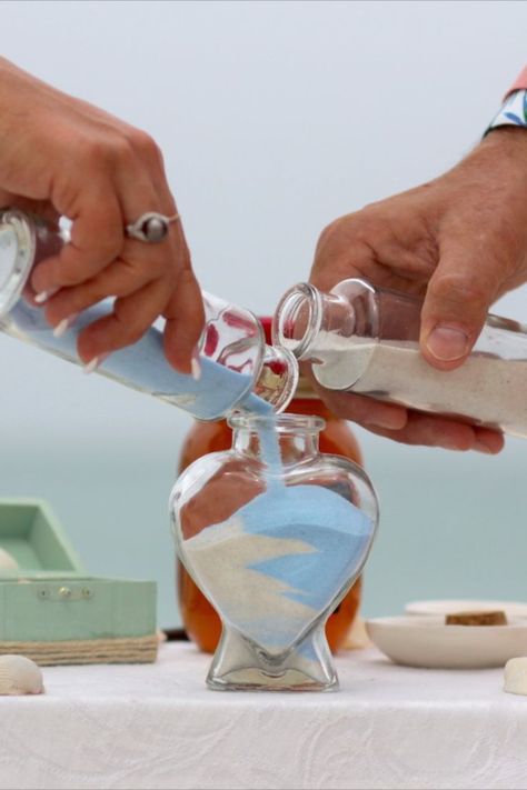 Unity Sand Jar Ceremony Wedding Ritual | Sarasota Florida Beach Wedding Service | Beach Wedding Planners | Florida Sun Weddings | Wedding Couple Pours Different Colored Sand into a Heart Shaped Jar | Wedding Memento | Beach Wedding Ideas Inspiration | Get Married on the Beach | Beach Wedding Ceremony Ideas | Blessign Shell Wedding Ritual Magenta Wedding Decorations, Sand Jar, Ariel Wedding, Magenta Wedding, Sand Ceremony Wedding, Wedding In Florida, Wedding Ceremony Unity, Unity Sand Ceremony, Unity Sand