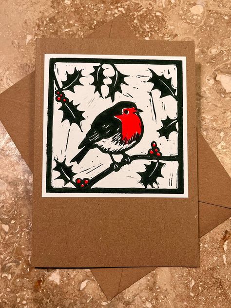 This original linocut greetings card depicting a robin amongst holly is hand-printed on recycled 280gsm Kraft card with matching 120gsm envelope.  It measures 5 x 7 inches (approximately 127 x 178mm) and comes in a recyclable/compostable bag. From initial design to final product, every aspect of this card has been created by hand. The card is left blank inside for your personalised message and would be perfect for many occasions including Christmas, the holiday season, birthdays, anniversaries, Christmas Lino Print Cards, Christmas Cards Lino Print, Christmas Linocut Ideas, Christmas Lino Print Ideas, Handprint Christmas Cards, Lino Ideas, Artsy Gift, Print Christmas Card, Recycled Art Projects