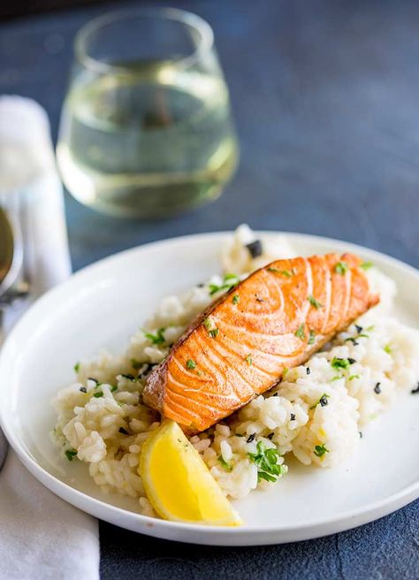 This Seared Salmon with Lemon Risotto is an elegant main course perfect for entertaining or if you are spending date night at home. A creamy risotto and a crispy seared salmon fillet, all coming together with plenty of lemon, parsley and black pepper. With this simple recipe you can create this restaurant quality dish easily at home. The lemon risotto makes a great rice side dish for the succulent salmon. Grilled Salmon Dinner, Lemon Risotto Recipes, Salmon Risotto, Lemon Risotto, Salmon Dinner Recipes, Side Dishes For Salmon, Salmon With Lemon, Creamy Risotto, Date Night At Home