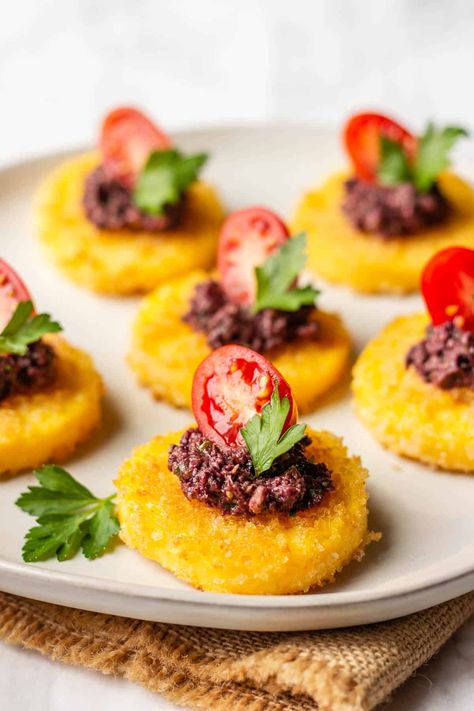 rick. Tubed polenta is fried until crispy and then topped with a tangy Kalamata Olive-Caper spread. Easy and mouthwatering appetizer that everyone will love. Polenta Appetizer, Polenta Bites, Black Olive Tapenade, Crispy Polenta, Grilled Polenta, Canapes Recipes, Thanksgiving Appetizer Recipes, Black Bean Salsa, Polenta Recipes