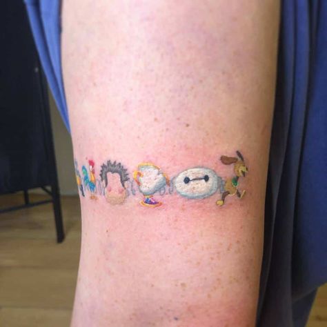 Small Cute Disney Tattoos courtenaydicksontattoo Disney Arm Band Tattoo, Funko Pop Tattoo Ideas, Small World Tattoo Disney, Best Disney Tattoos, Disney Movie Inspired Tattoos, Disney Forearm Tattoo Women, Small Pixar Tattoos, Disney Wrap Around Tattoo, Small Moana Tattoos Ideas