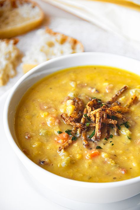 This hearty and cozy yellow split pea soup is flavored with an aromatic sprinkle of marjoram, and topped with savory crispy-fried onions! | thecozyapron.com #yellowsplitpeasoup #yellowsplitpeasoupwithham #yellowsplitpeasouprecipes Yellow Split Pea Recipe, Yellow Split Pea Soup, Yellow Lentils, Yellow Split Peas, Split Pea Soup Recipe, Ham Soup, Split Pea Soup, Pea Soup, Crispy Onions