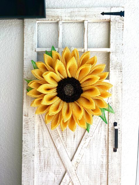 A summertime sunflower wreath for your front door, a Mother’s Day gift, a cheerful cemetery marker. My wreaths are one of a kind and constructed thoughtfully and securely. You will not be disappointed and this flower will look stunning to all who see it.This sunflower wreath measures approximately 23” across x 20” up and down x 5” deep and is constructed on a wire wreath base with a hand-made center, poly burlap mesh, plastic canvas mesh, chenille stems, zip ties, hot glue and a beautiful backin Tropical Floral Wreath, Lanai Decor, Sunflower Wreath Diy, Sunflower Door, Tropical Wreath, Spring Wreath For Front Door, Sunflower Crafts, Candy Wreath, Mothers Day Wreath