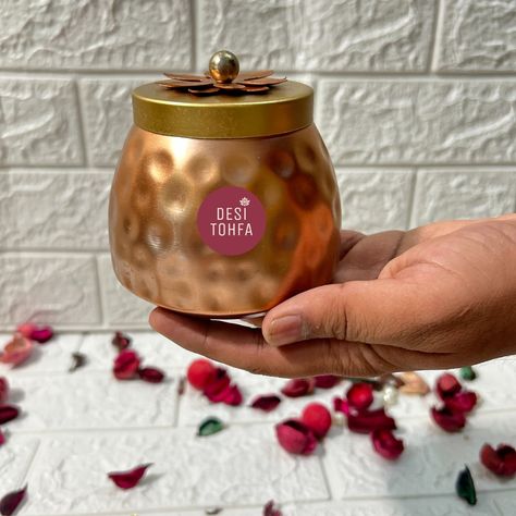 Add a touch of elegance to your gifts with these exquisite Metal Jars with Copper Finish and Lotus Lid. Order now and make every occasion unforgettable! 🫙❤️ ✅Bulk Order Accepted 🌏 Global Fast Shipping Whatsapp at: +91 9680460596 www.desitohfa.com ( metal jars, golden jars, return gifts, wedding favors, housewarming gifts, return gifts and favors, haldi gifts, mehndi gifts, wedding gifts, copper jars, dry fruit jars, chocolates jars, packaging material, indian handicrafts, indian gifts, bul... Housewarming Return Gifts Indian, Return Gifts For Wedding Indian, Jars Packaging, Return Gifts Indian, Housewarming Return Gifts, Chocolate Jar, Fruit Jars, Indian Handicrafts, Indian Gifts