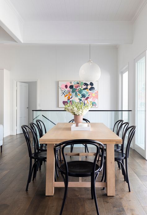 Timber dining table and black Thonet chairs in Hamptons style Queenslander home. #diningtable #diningspace #queenslander #hamptonstyle Dining Table Hamptons Style, Oak Dining Table Black Chairs, Modern Hampton Dining Table, Oak Table With Black Chairs, Timber Dining Table Black Chairs, Timber Dining Table White Chairs, Dark Timber Dining Table, Modern Hamptons Style, Thonet Dining Chairs