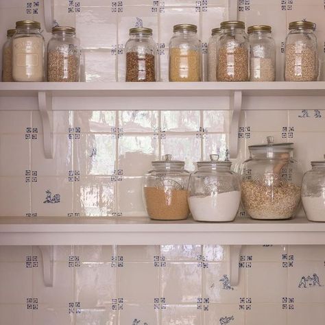 Emma Milne on Instagram: "Love this little pantry featuring beautiful handmade delft tiles from @plainenglishdesign on all of the walls! I’m a bit all or nothing when it comes to tiles, either cover the whole space or leave them out. 

We think they look beautiful here with the yellow pantry cupboards and glazed door. Also, there is a gorgeous pendant light out of shot with its glazed ceramic finish, which pairs beautifully. 

We stole some space from the hall to carve out this pantry, which is perfectly positioned near the fridge and cooking areas in the kitchen of our South Kensington project. 

Hope you like it too.

Interiors @emmamilneinteriors 
Photography @hana.snow" Yellow Pantry, Cupboard Colours, Pantry Cupboard, Delft Tiles, Apartment Aesthetic, South Kensington, Glazed Door, February 8, Little Cottage