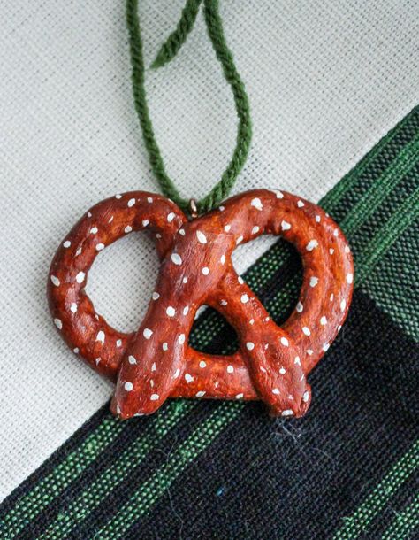 "Give your Christmas Tree a POP with this Handmade Pretzel Christmas Ornament!  This listing if for ONE Pretzel Clay Ornament. It measure approx 4\" with a screw eye  and twine on top for easy hanging.  * Size and colors may vary slightly. These ornaments are handmade and one of a kind- please handle gently and carefully* Shipping times are Approximate! Thanks!" Pretzel Christmas, Salt Dough Christmas Ornaments, Handmade Felt Ornament, Decor Gift Ideas, Christmas Holiday Decor, Christmas Clay, Clay Ornaments, Ceramics Ideas Pottery, Homemade Christmas Gifts