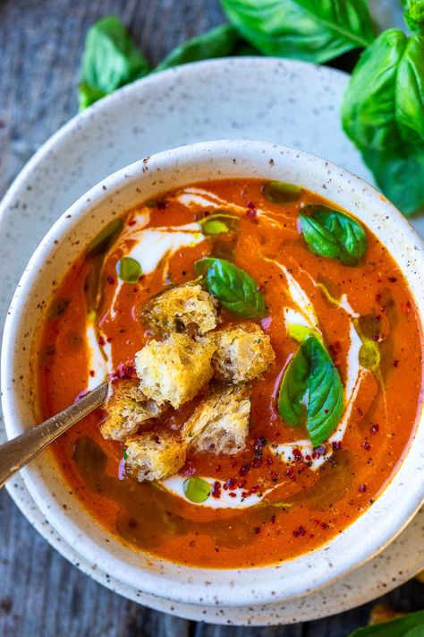 Roasted Red Pepper Tomato Soup is a twist on classic tomato soup, with the delicious sweetness and smoky flavor of roasted red peppers and tomatoes. Top with croutons and fresh basil. Vegan. Tomato Soup With Peppers, Tomato Soup With Pesto, Roasted Tomato Red Pepper Soup, Roasted Red Pepper Tomato Basil Soup, Low Cal Tomato Soup, Protein Tomato Soup, Roasted Pepper And Tomato Soup, Roasted Red Pepper And Tomato Soup, Roast Tomato Soup