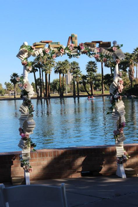 Book - Bibliophile themed wedding arch. Vintage books stacked on top, handmade book page roses, book page swags - garlands. 90% upcycled materials! Wedding Arch With Flowers, Arch With Flowers, Book Arch, Books Stacked, Book Page Roses, Book Themed Wedding, Literary Wedding, Roses Book, Wedding Arch Flowers