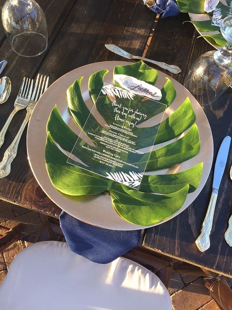 gold chargers & cutlery, monstera leaf under acrylic menu with navy blue linen napkins on wooden farm tables - lovely Monstera Leaf Charger, Tropical Wedding Centerpieces, Tropical Wedding Inspiration, Gold Chargers, Tropical Wedding Flowers, Tropical Bridal Showers, Tropical Baby Shower, Tropical Wedding Invitations, Navy Blue Linen