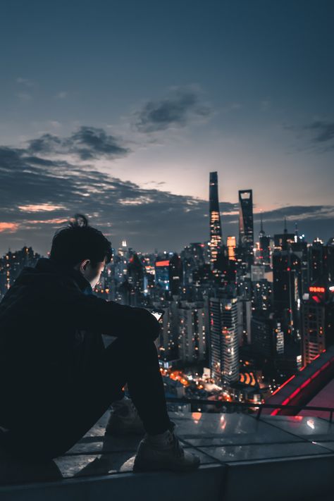 man sitting on roof top during nighttime photo – Free Human Image on Unsplash Sitting On Roof Aesthetic, On Roof Aesthetic, Sitting On Roof, Cyberpunk City, Ocean Wallpaper, Beach Wallpaper, Man Standing, Dark Photography, Parkour