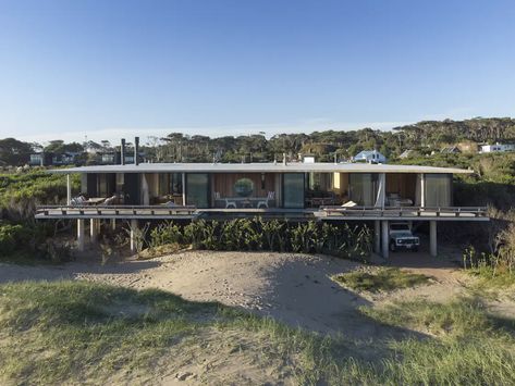 Photo 2 of 19 in This Airy Home on Stilts Is One South American Family’s Beach Retreat for All Seasons - Dwell Home On Stilts, Stilt Home, House Martin, Concrete Siding, Fish Gallery, Elevated Home, Martin House, Public Architecture, Fish House