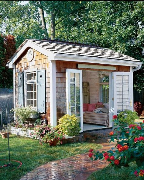 The Quaint Escape:  With a cozy daybed and French doors that swing open to a charming and lush garden, this she-shed is the ultimate spot for whiling away a summer afternoon. Adding Windows To Shed, Shed Bedroom Ideas Backyards, Unique Backyard, Backyard Art, Backyard Barn, Wooden Shed, Backyard Getaway, Backyard Storage Sheds, Shed Decor