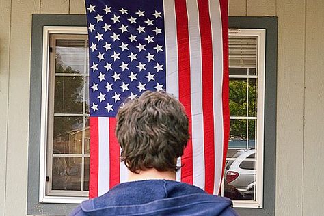 Display of the American flag is governed by the Federal Flag Code that explains, among other details, the rules for hanging a flag vertically. The regulations ensure that the flag is treated with respect as a symbol of national identity and pride. Most of the time, the flag is flown horizontally, but when it is practical or necessary to hang the... Flag Hanging Ideas Outside, Flag Hanging Ideas, American Flag On Porch, Flags On Wall, Flag On Porch, Gb Flag, Flag Code, Hanging Flags, Flag Hanging