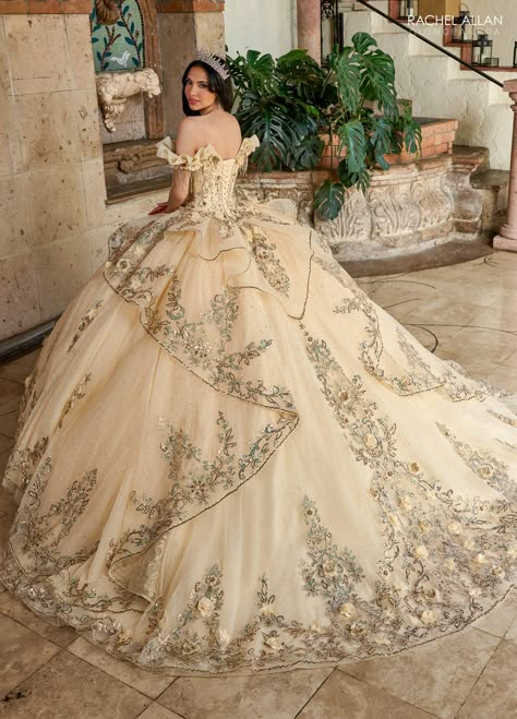 Sparkle under the stars in this 3D floral applique long off the shoulder corset dress with A-line skirt by Rachel Allan RQ3137. This fabulous quinceañera gown is a stunning spectacle of bold and gold, designed to captivate and enchant. The dress features a bold fabric with luxurious gold embroidery that embellishes the entire gown, creating a regal and opulent appearance. The sweetheart neckline is framed by delicate off-the-shoulder sleeves, adding a touch of romance and sophistication. The vol White And Gold Quince, Quinceanera Songs, Off The Shoulder Corset Dress, Gold Quince Dress, Dama Dresses Quinceanera, White Quince, Xv Dresses, Quinceanera Tiaras, Quinceanera Themes Dresses