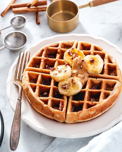 This easy banana waffles recipe transforms ripe bananas into a golden, fluffy breakfast! Packed with warm cinnamon and a burst of fruit, these waffles are begging to be devoured smothered in maple syrup. #banana #bananawaffles #wafflesrecipe #bananawafflesrecipe #breakfast #breakfastrecipe #easybreakfast #easywaffles #waffle #bananawaffle Banana Waffle Recipe, Banana Waffles, Waffles Easy, Belgian Waffle Maker, Waffles Recipe, Cinnamon Milk, Ripe Bananas, Belgian Waffles, Cinnamon Banana