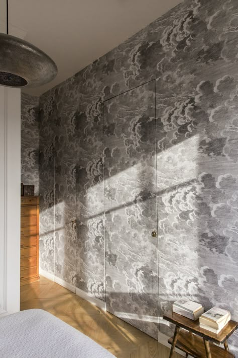 Photo 10 of 12 in A Historic Apartment in Rome Is Treated to a Dramatic New Look - Dwell Cloud Wallpaper Bedroom, Wallpaper Interiors, Fornasetti Wallpaper, Historic Apartment, Hidden Doors, Slanted Ceiling, Light Hardwood, Light Hardwood Floors, Bedroom Pendant