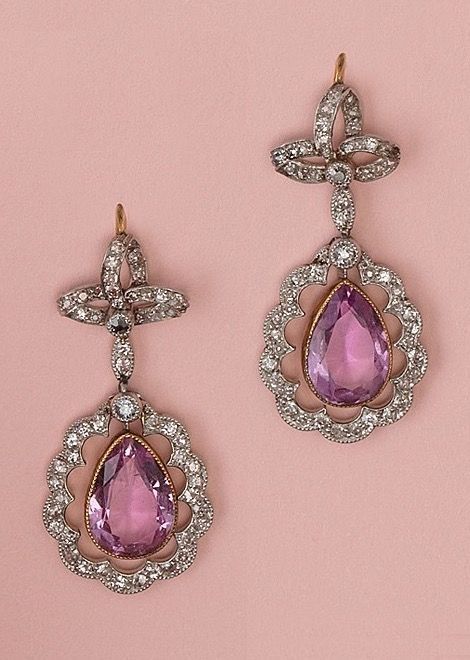 A pair of Edwardian platinum, diamond and pink topaz earrings, English, circa 1910. Edwardian Vampire, 1910 Jewelry, Convertible Jewellery, Pink Topaz Jewelry, Edwardian Earrings, Convertible Jewelry, Pink Topaz Earrings, Antique Diamond Jewelry, Pink Sapphire Earrings