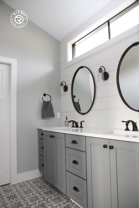 Fresh, clean, bright modern farmhouse bathroom with white shiplap walls, round mirrors, Artisan Cardiff porcelain floor tile | Riemco Design + Build, Custom Homes in Ann Arbor, MI Bathroom With White Shiplap, Farmhouse Bathroom With Shiplap, Bright Modern Farmhouse, Bathroom With Shiplap, Bathroom Round Mirror, Shiplap Bathroom Wall, White Shiplap Walls, Modern Homestead, Family Homestead