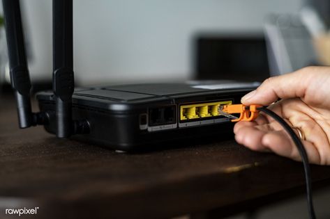 Man plugging in an ethernet cable to a wireless router | free image by rawpixel.com / Teddy Rawpixel Router Wifi, Modem Router, Wireless Routers, Wifi Signal, Internet Providers, Fast Internet, Internet Service Provider, Wireless Internet, Wireless Router