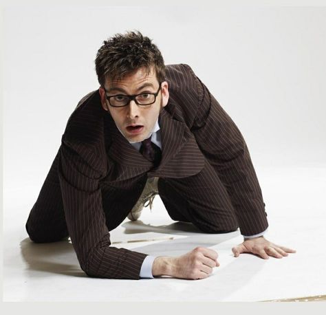 Picture of Scottish actor David Tennant as the 10th Doctor from the tv show Doctor Who. He's wearing a brown suit and glasses while kneeling on the ground. The 10th Doctor, Doctor Who 2005, Doctor Who 10, David Tennant Doctor Who, Husband Material, David Michael, 10th Doctor, 11th Doctor, Tenth Doctor